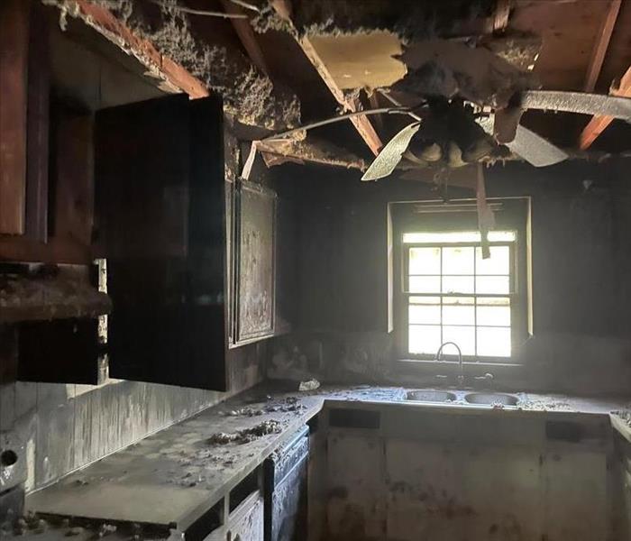 soot covering walls and cabinets in kitchen ceiling has fallen